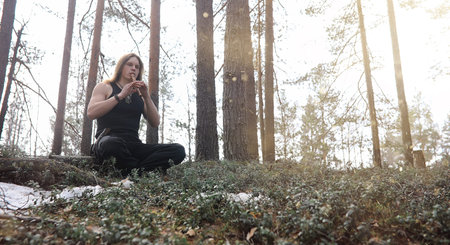 A musician with a tool in nature. A man is playing a flute in aの写真素材