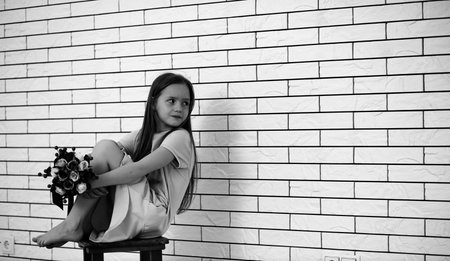 little girl on a chair black and whiteの写真素材