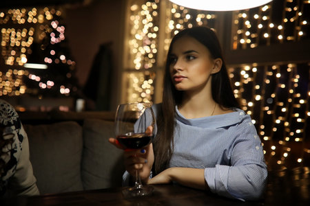 A girl in an evening dress sitting in a cafeの写真素材