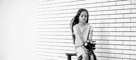 little girl on a chair black and whiteの写真素材