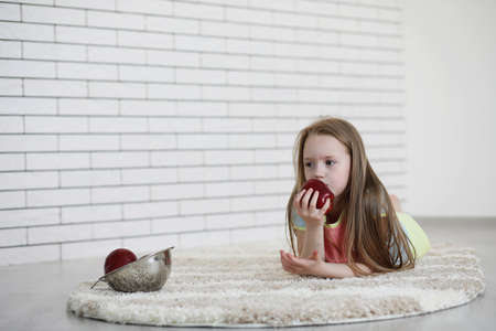 little girl lies on the floorの写真素材