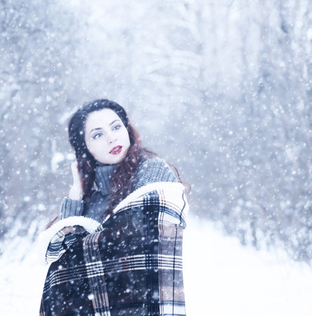 Beautiful girl in a beautiful winter snowの写真素材