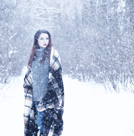 Beautiful girl in a beautiful winter snowの写真素材