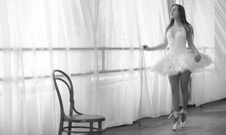 Young ballet dancer on a warm-up. The ballerina is preparing toの写真素材