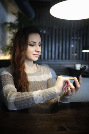 Beautiful girl in a cafeの写真素材