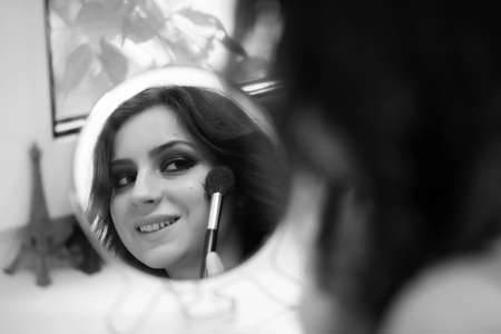 Girl doing makeup black and whiteの写真素材