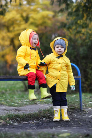 Children in the autumn park walkの写真素材