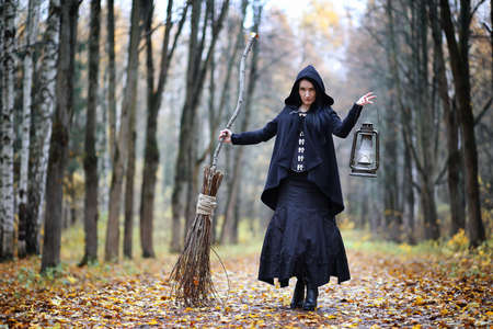 A woman in a witch suit in a forestの写真素材