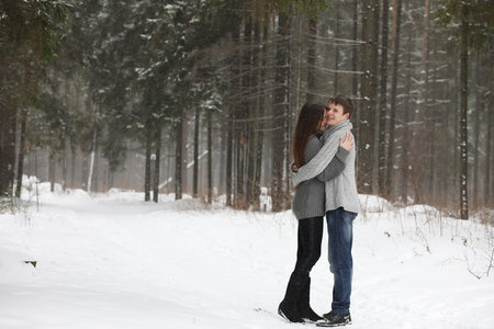 pair of lovers on a date winter afternoon in a snow blizzard
