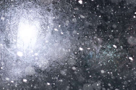 Texture of ice in winter. Pieces of frozen water on a street in the winter. The texture and texture of the frozen water in winter and outdoor.の写真素材