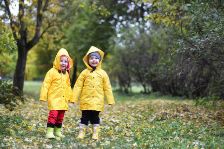 Children in the autumn park walkの写真素材
