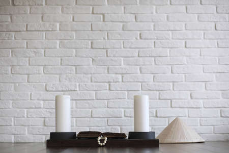 Asian young novice on a white brick wall backgroundの写真素材