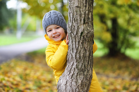 Children in the autumn park walkの写真素材