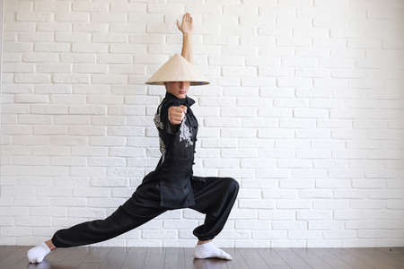 Asian young novice on a white brick wallの写真素材