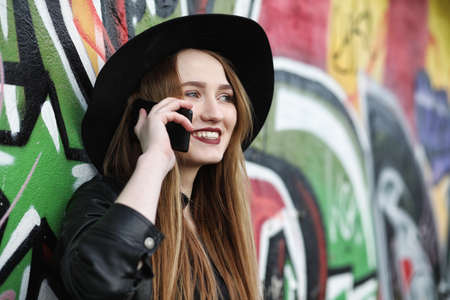 Young beautiful girl in a hat and with a dark make-up outside. Gの写真素材