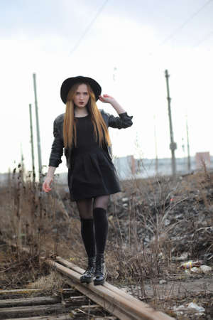 A girl walks down the city street in a leather waistcoatの写真素材