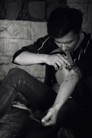 A young man takes drugsの写真素材