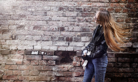 Beautiful young girl rocker with electric guitar. A rock musicianの写真素材