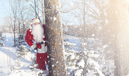 Santa Claus comes with gifts from the outdoor. Santa in a red suの写真素材