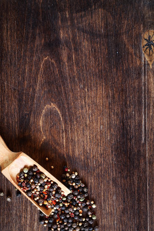 Mixture of peppers for cooking on a wooden background