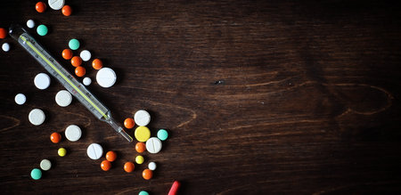 Drugs and pills on a wooden table. Various means to prevent coldの写真素材