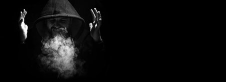 A man in a black hood and fistsの写真素材