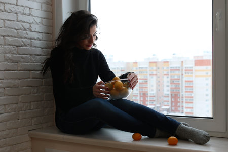 A young woman look on the window