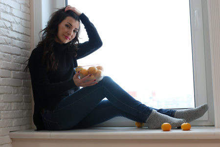 A young woman look on the windowの写真素材