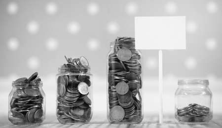 Coins in a jar on the floor. Accumulated coins on the floor. Savの写真素材