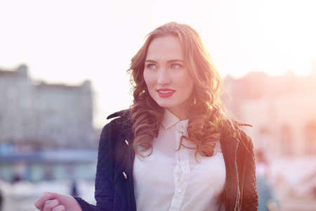 Girl business woman in the spring on a walk in a coatの写真素材