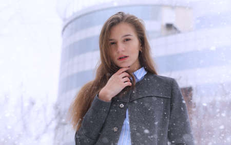 Young girl outdoors in winter. Model girl posing outdoors on a wの写真素材