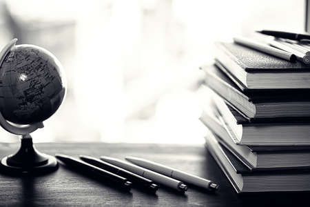 A stack of textbooks on the windowsill and writing utensilsの写真素材