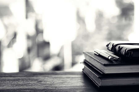 A stack of textbooks on a tableの写真素材