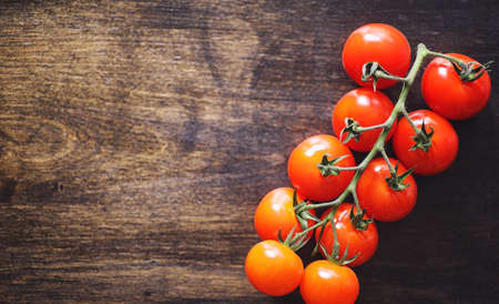 Branch with fresh cherry tomatoes. Ripe red tomatoes.の写真素材