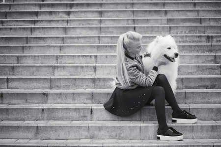 Lovely girl on a walk with a beautiful dogの写真素材