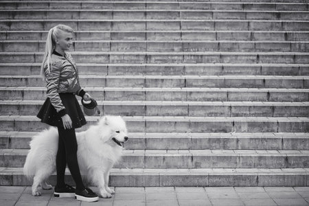 Lovely girl on a walk with a beautiful dog