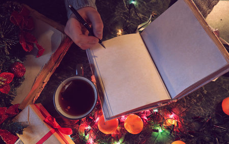 man with a blank book in his hands for the New Years table withの写真素材
