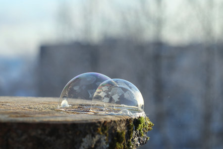 Soap bubbles freeze in the cold. Winter soapy water freezes in tの写真素材