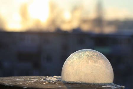 Soap bubbles freeze in the cold. Winter soapy water freezes in tの写真素材