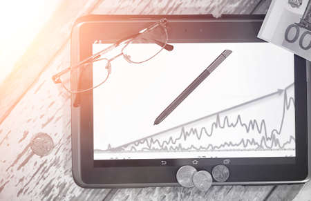 The graph of income growth. Electronic tablet with a graph of grの写真素材