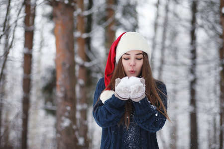 A young girl in a winter park on a walk.の写真素材
