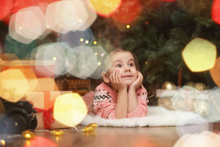 Little girl in new years Christmas atmosphere. The girl is happの写真素材