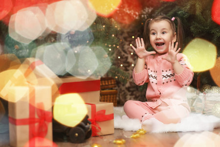 Little girl in new years Christmas atmosphere. The girl is happの写真素材