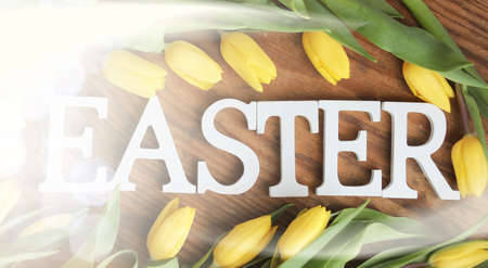 bouquet of yellow tulips in a vase on the floorの写真素材