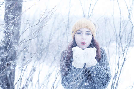 Beautiful girl in a beautiful winter snowの写真素材