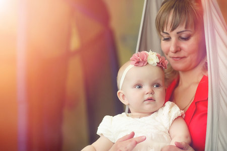 Baby in the arms of the girl. Mom holds her child in her arms. Hの写真素材