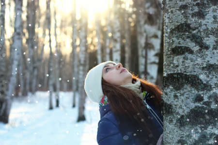 snow winter portrait female outdoor in a parkの写真素材
