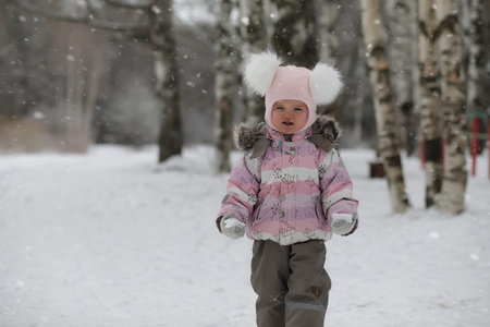 Children walk in the park in winter. Winter forest family with children on a walk. A cold winter day...