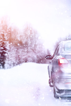 the car stands on a snow-covered road in a wintertime cloudy day