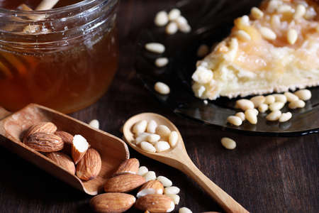 Fresh nuts on the table for breakfast with honey and cakeの写真素材